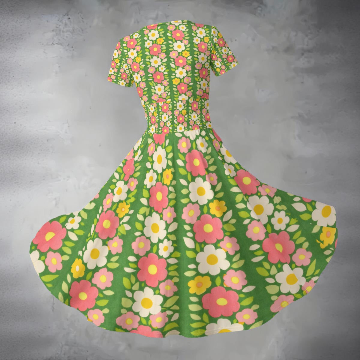 Floral dress with pink, yellow, and white flowers on a green background against a gray textured background