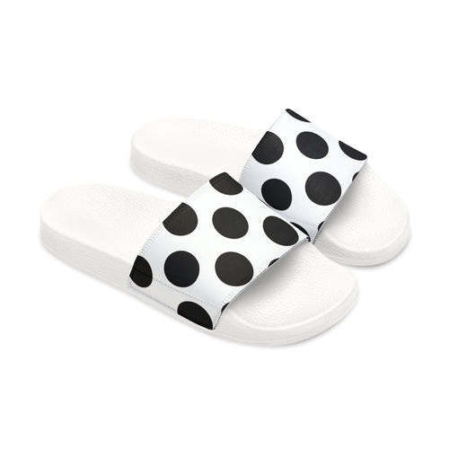 White slides with black straps featuring gold designs on a white background