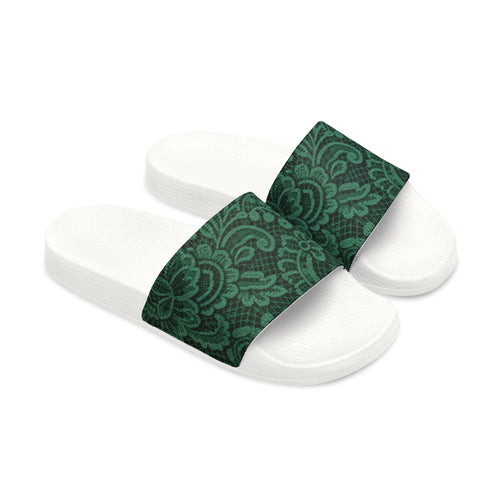 White slides with black straps featuring gold patterns on a white background