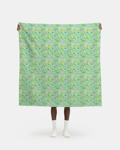 Person holding a large green patterned fabric against a white background