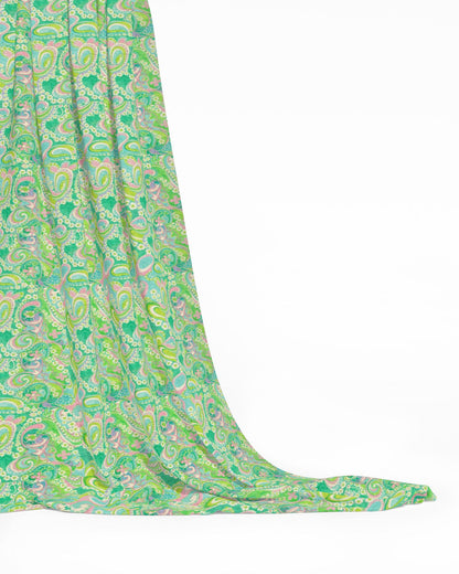 Green and pink paisley patterned fabric on a white background