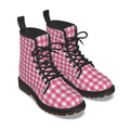 A pair of pink and white gingham checkered lace-up ankle boots with black laces, black collar lining, and dark brown soles, shown on a white background.