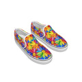 A pair of slip-on canvas sneakers with a vibrant, multicolored daisy floral print on a clean white background.
