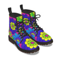 A pair of lace-up ankle boots with a vibrant 70s-style floral pattern featuring purple, blue, green, and yellow flowers on a dark background, shown against a plain white background.