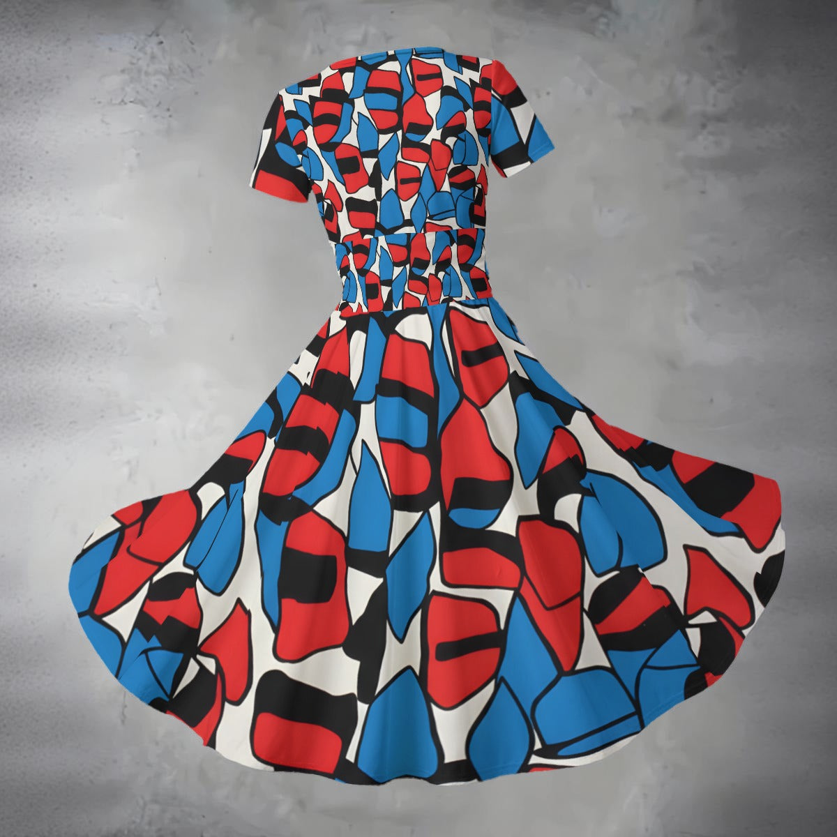 Colorful geometric-patterned dress on a gray background
