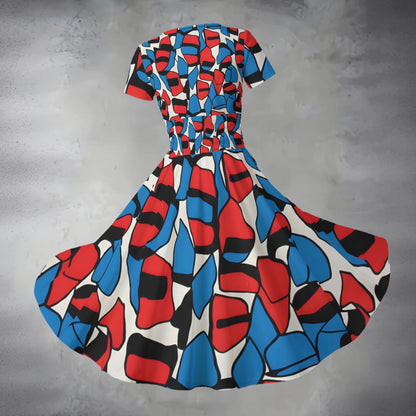 Colorful geometric-patterned dress on a gray background