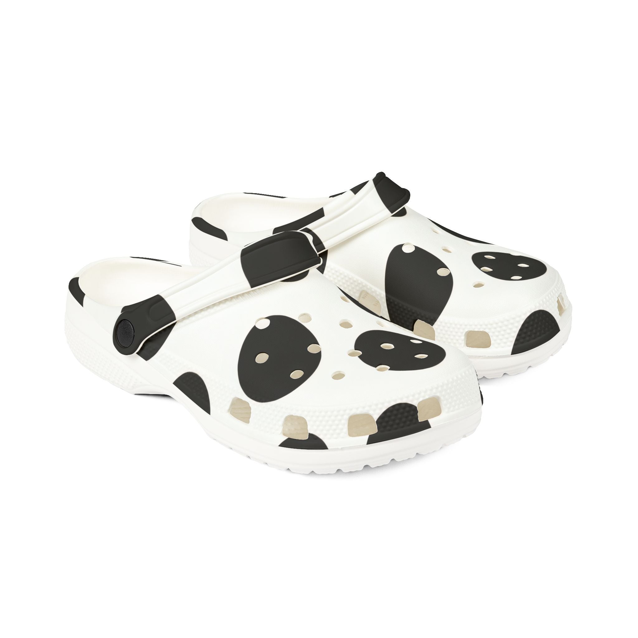 A pair of white clogs with a black and beige spotted pattern, shown on a clean white background.