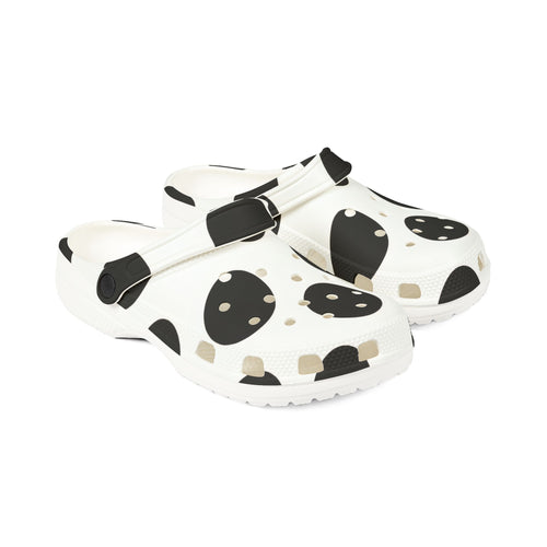 A pair of white clogs with a black and beige spotted pattern, shown on a clean white background.