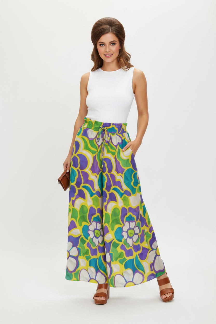 Model wearing psychedelic floral wide-leg palazzo pants — 60s retro style