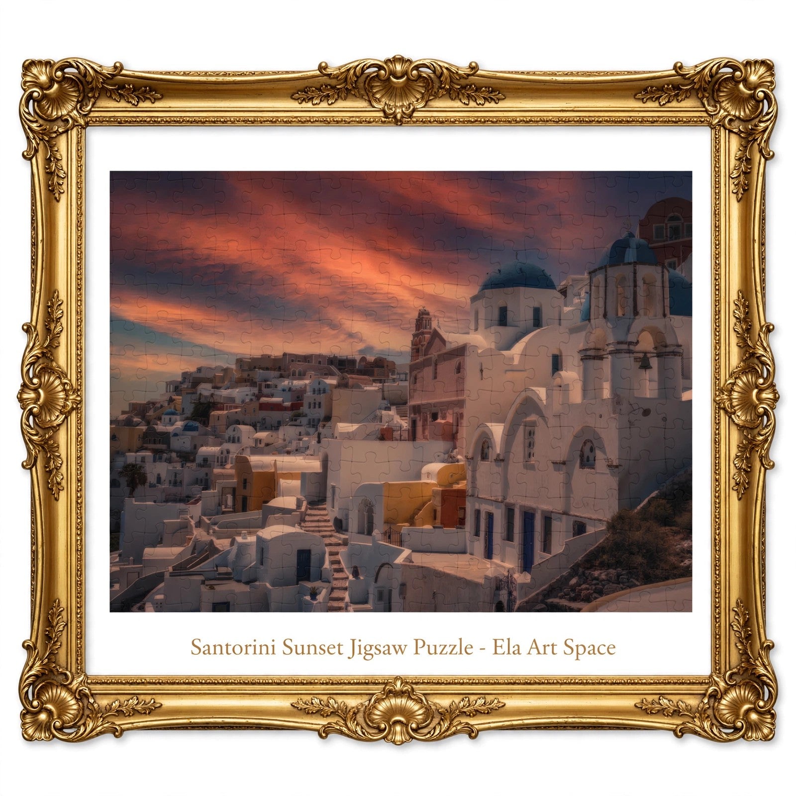 A framed Santorini sunset jigsaw puzzle by Ela Art Space, featuring an ornate gold frame and a print of white buildings, domes, and a dramatic orange-pink sky.